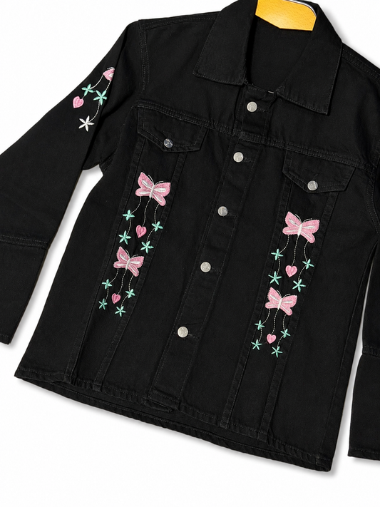Women's black denim jacket with pink bow embroidery – angled view