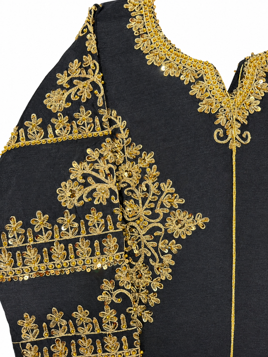 Golden embellished neckline and sleeve detail on black dress