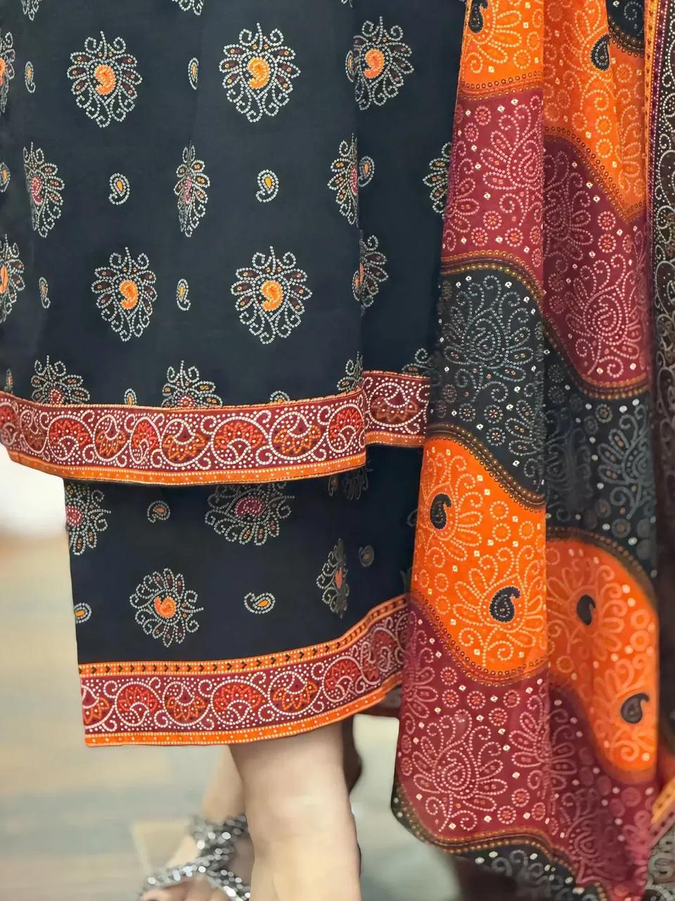 Close-up of patterned fabric with orange and blue design