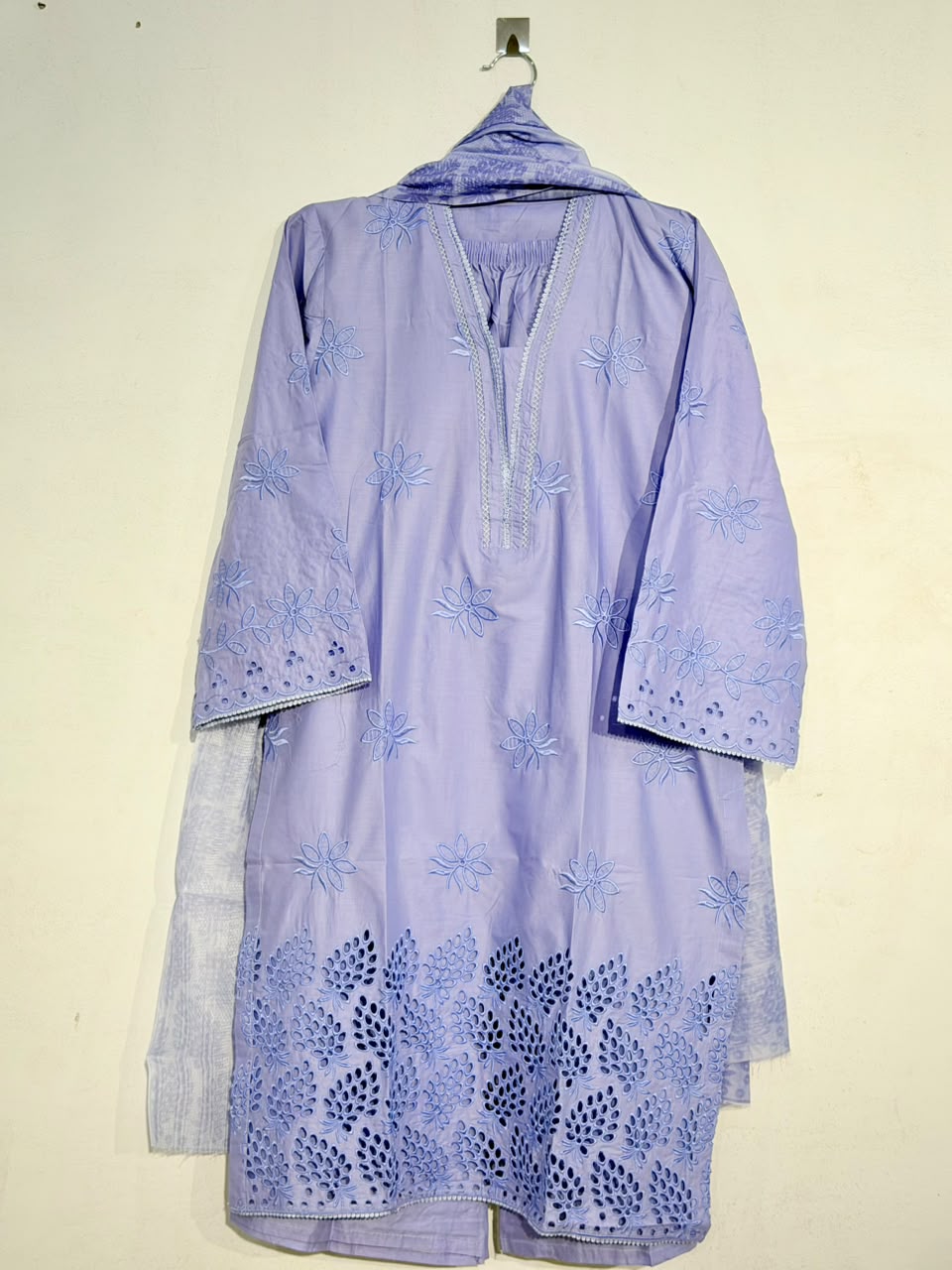 Light purple embroidered dress with a matching jacket on a beige background