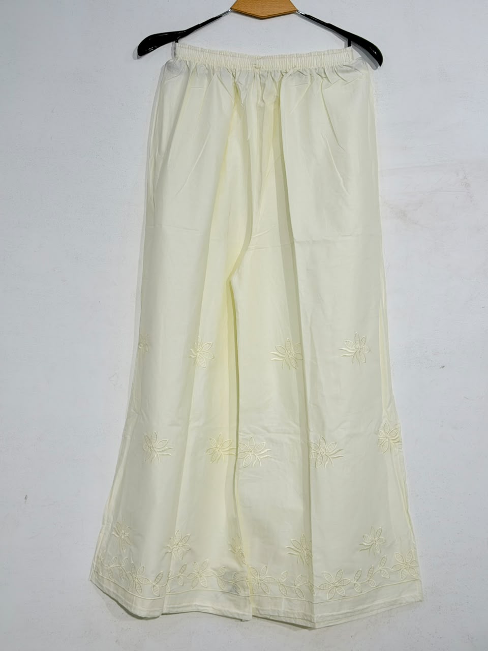 Cream-colored skirt with floral embroidery on a white background
