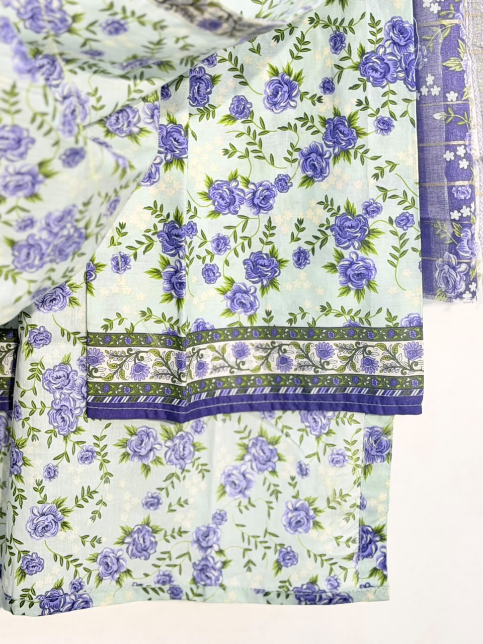 Ice blue floral print and trouser border close-up