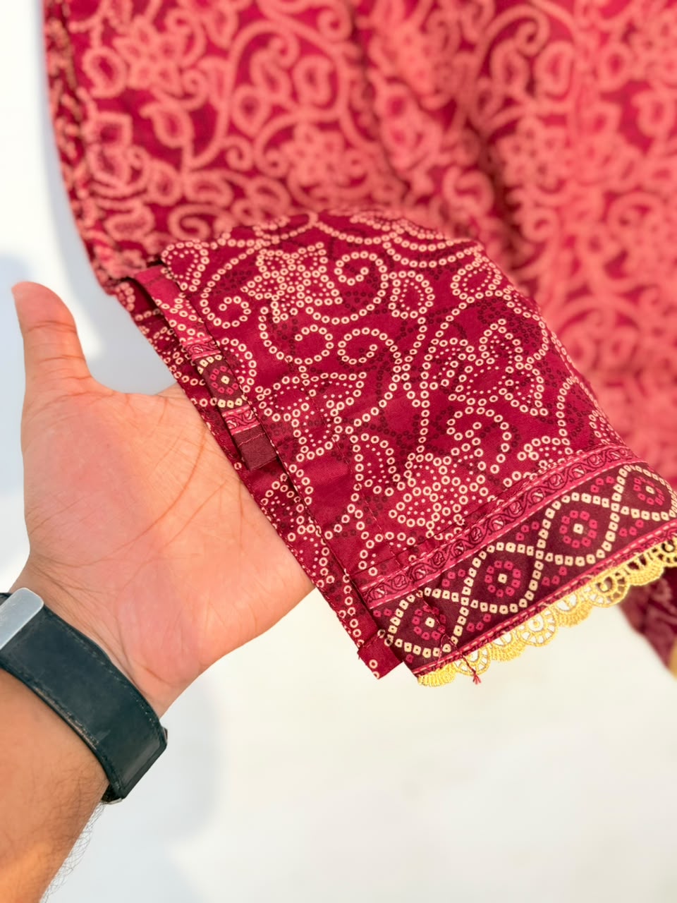 Embroidered cuff with gold lace trim close-up