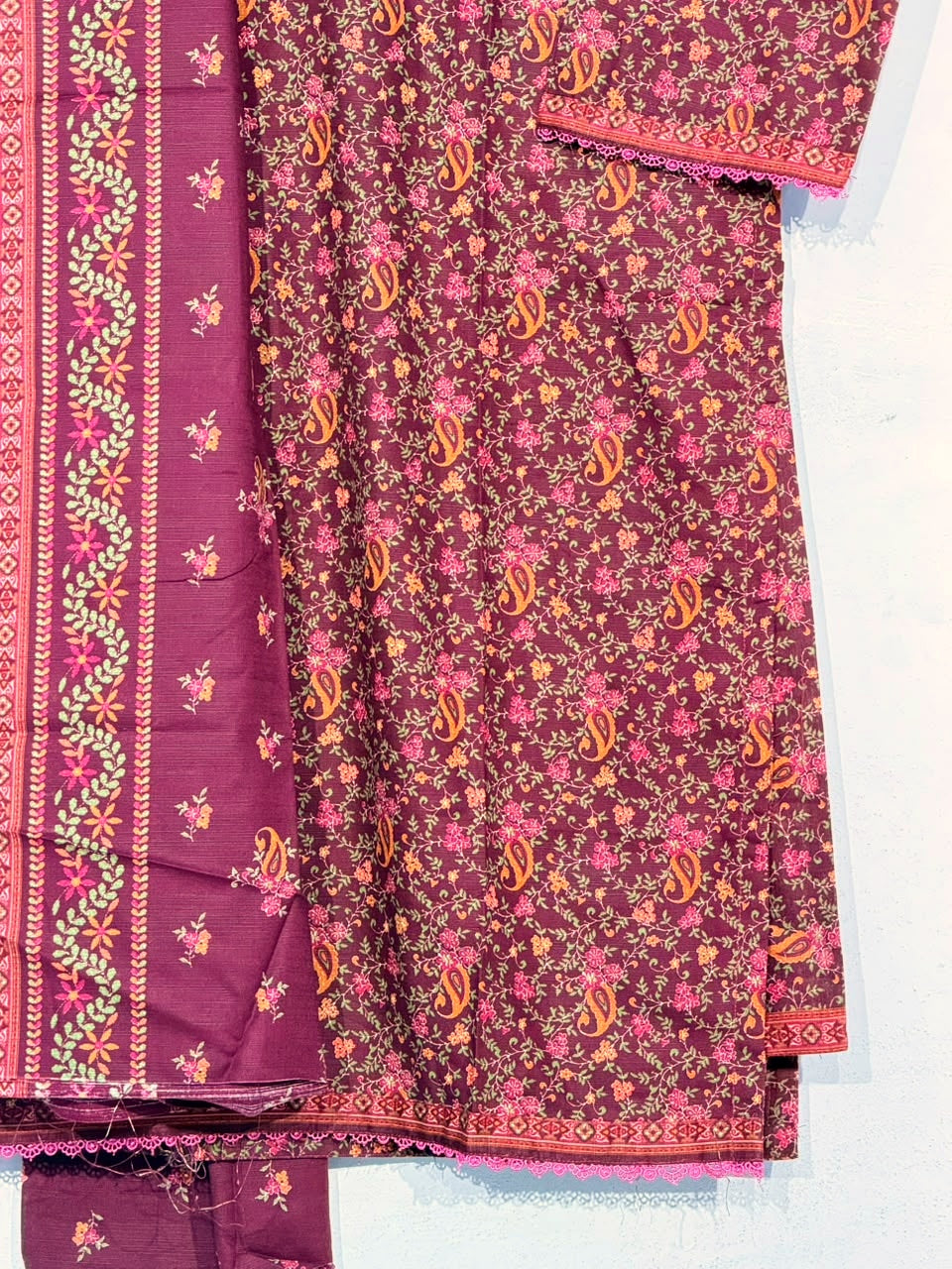 Polished close-up of the original maroon floral fabric, dupatta and border