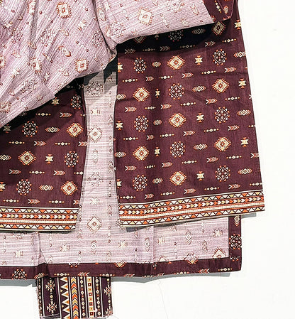 Close-up of the maroon geometric print, matching reverse fabric and trouser border of the Bin Saeed Khaddar suit