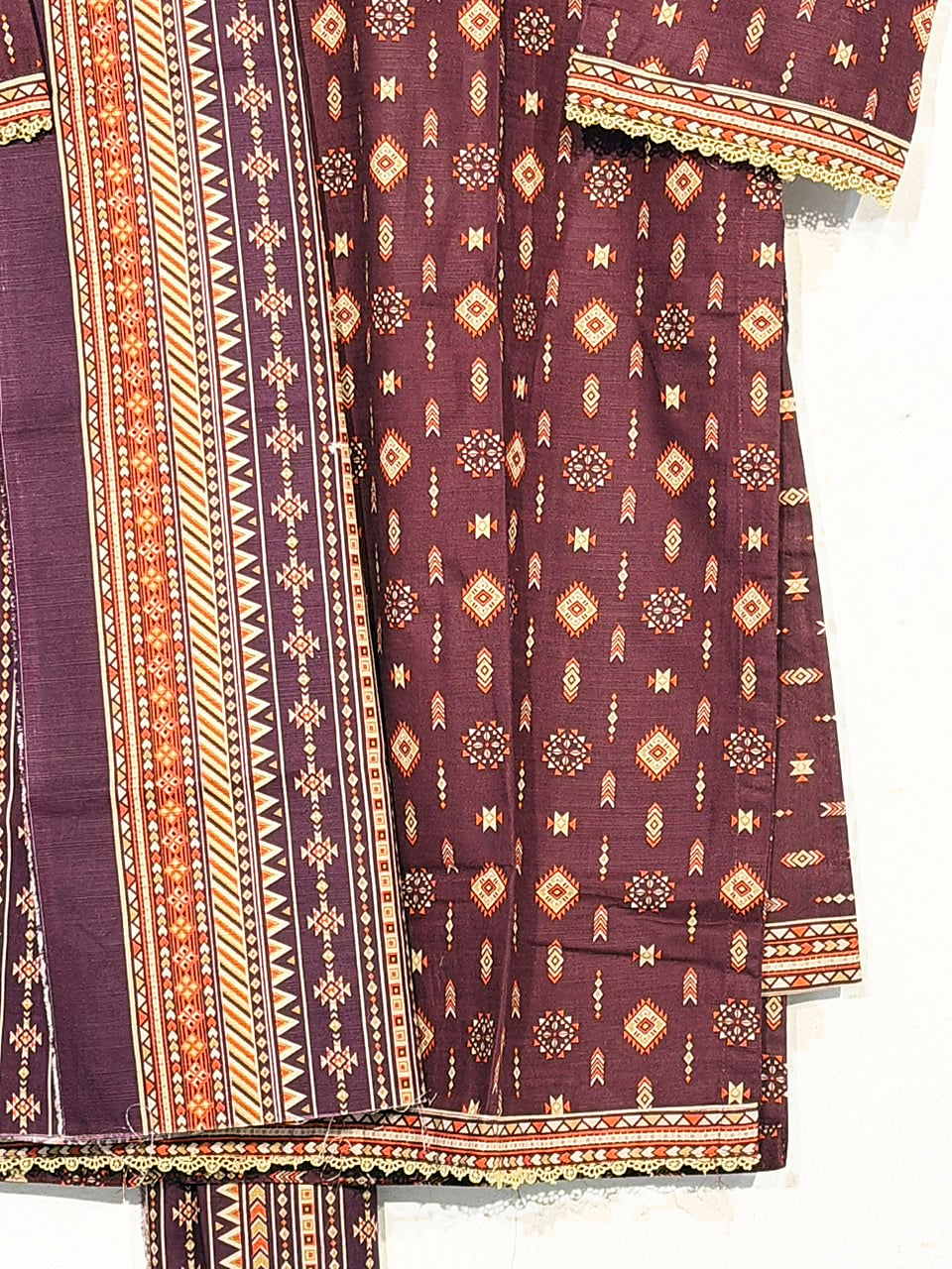 Close-up of geometric print, fabric texture and border on Bin Saeed maroon Khaddar suit