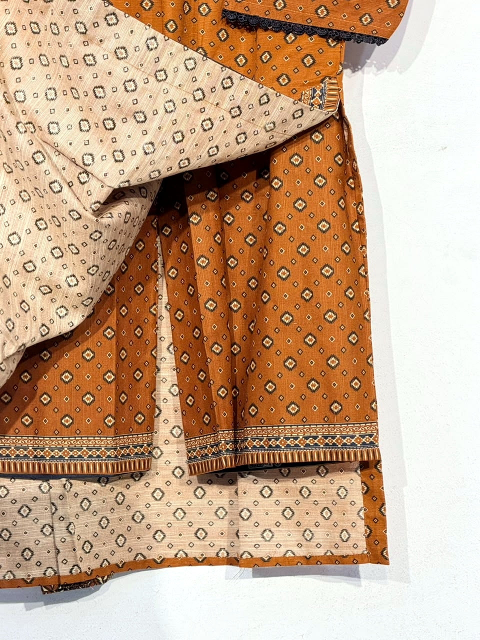 Polished detail photo of matching mustard trouser and reverse fabric