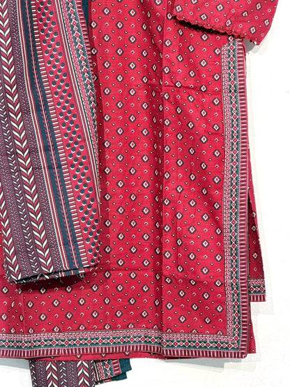 Polished close-up of red fabric print, teal dupatta and border