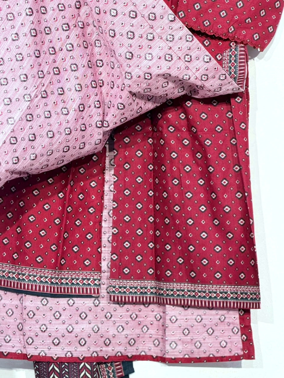 Polished detail of red Khaddar fabric, matching trouser and reverse side